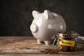 Piggy bank and jar of coins with word PENSION on table Royalty Free Stock Photo