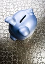 Piggy bank on jigsaws Royalty Free Stock Photo