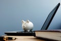 Piggy bank on a laptop. Online savings or banking concept. Royalty Free Stock Photo