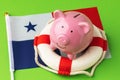 Piggy bank, lifebuoy and flag on a blue background, the concept of saving the Panama economy Royalty Free Stock Photo