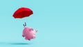 Piggy bank lifted by red umbrella on blue background. Savings growth concept