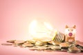 A piggy bank or light bulb are stack on coins pile for saving money concept. Creative idea of financial Royalty Free Stock Photo