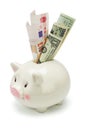 Piggy bank and major world currency notes Royalty Free Stock Photo