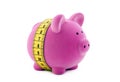 Piggy bank with measure tape Royalty Free Stock Photo