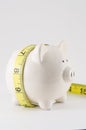 Piggy bank with measure tape Royalty Free Stock Photo
