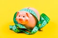 Piggy bank and measuring tape. Budget limit concept. Credit loan debt. Financial consulting. Economics and finances. Pig Royalty Free Stock Photo