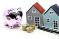 Piggy bank and model house with money,coins,Savings for real est Royalty Free Stock Photo