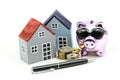 Piggy bank and model house with money,coins,Savings for real est Royalty Free Stock Photo