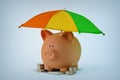 Piggy bank with money under rainbow umbrella - Concept of savings, money protection and financial security Royalty Free Stock Photo