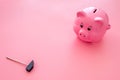 Piggy bank. Moneybox in shape of pig near hammer on pink background copy space