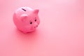 Piggy bank. Moneybox in shape of pig on pink background copy space