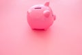 Piggy bank. Moneybox in shape of pig on pink background copy space