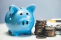 Piggy bank next to a stack of coins. Accumulation of money for personal purposes. Royalty Free Stock Photo