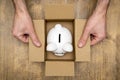 Piggy bank in open box made from corrugated cardboard Royalty Free Stock Photo