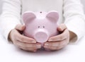 Piggy bank protected by hands Royalty Free Stock Photo