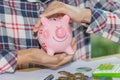 Piggy bank protected by hands, Savings protection, Financial hedging, Risk management. Royalty Free Stock Photo