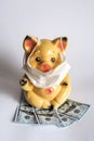 Piggy bank with protective mask against coronavirus virus affects finances. NCOV-19 affects the economy