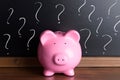 Piggy bank with question mark on black board Royalty Free Stock Photo