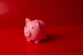 Piggy bank on red background Royalty Free Stock Photo