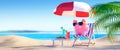 Pink piggy bank relaxing at the beach