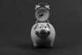 Piggy bank with retro alarm clock. Saving time concept Royalty Free Stock Photo