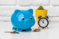 Piggy bank save coin and alarm clock, time and money concept. Royalty Free Stock Photo