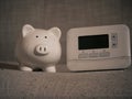 Piggy bank savings and central heating thermostat controls Royalty Free Stock Photo