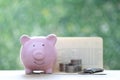 Piggy bank and stack of coins money with banking account book on natural green background, Save money for prepare in future and Royalty Free Stock Photo