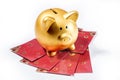 Piggy bank standing on red envelopes Royalty Free Stock Photo