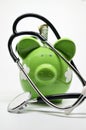 Piggy bank and stethoscope Royalty Free Stock Photo