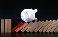 Piggy bank stopping the domino wooden effect concept for business Royalty Free Stock Photo