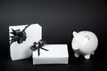 Piggy bank style money box and gifts isolated on black a background Royalty Free Stock Photo