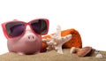 Piggy Bank with Sunglasses, Towel and Seashells on Royalty Free Stock Photo