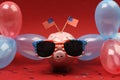 Piggy bank with sunglasses with USA flag and blue, red and white party balloons and two small USA flags on red background Royalty Free Stock Photo