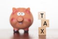 Piggy bank and TAX word Royalty Free Stock Photo