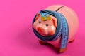 Piggy bank tied with measuring tape. Budget and squeezed savings Royalty Free Stock Photo
