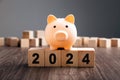 Piggy Bank on top of wooden block. Budget Plan 2024 Royalty Free Stock Photo