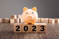 Piggy Bank on top of wooden block. Budget Plan 2023