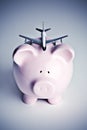 Piggy bank with toy airplane Royalty Free Stock Photo