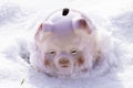 Piggy bank in traditional pink color. Ceramic toy on white snow. Pig as money box for savings and home budget. financial symbol Royalty Free Stock Photo