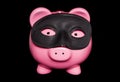 Piggy bank wearing black masquerade mask