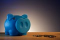 Piggy bank on a wooden base black background