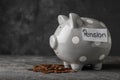 Piggy bank with word PENSION and coins on table Royalty Free Stock Photo