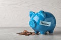 Piggy bank with word PENSION and coins on table Royalty Free Stock Photo