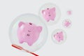 Piggy banks floating in soap bubbles - Concept of savings and economic insecurity