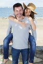 piggyback couple on shore Royalty Free Stock Photo