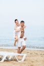 Piggyback. Guy carrying on shoulders his barefoot girlfriend Royalty Free Stock Photo