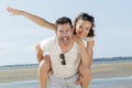 Piggybacks couple at beach Royalty Free Stock Photo