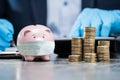 Piggybank With Face Mask During Coronavirus Pandemic Royalty Free Stock Photo