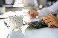 Piggybank In Front Of Businessperson